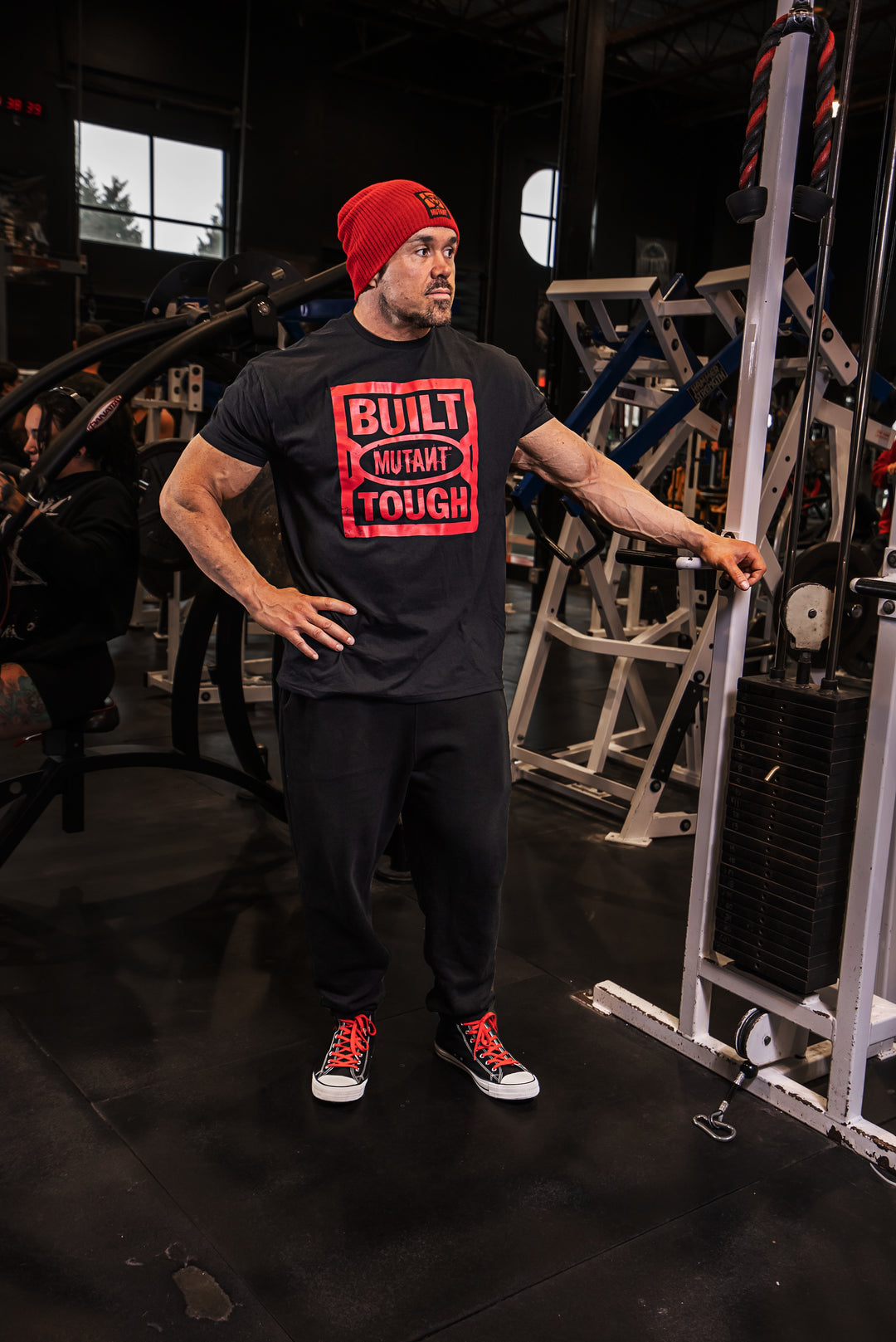 Big Ron Partlow at the gym wearing the black 'MUTANT's Truck Month' t-shirt that features the 'Built Mutant Tough' phrase in red letters.
